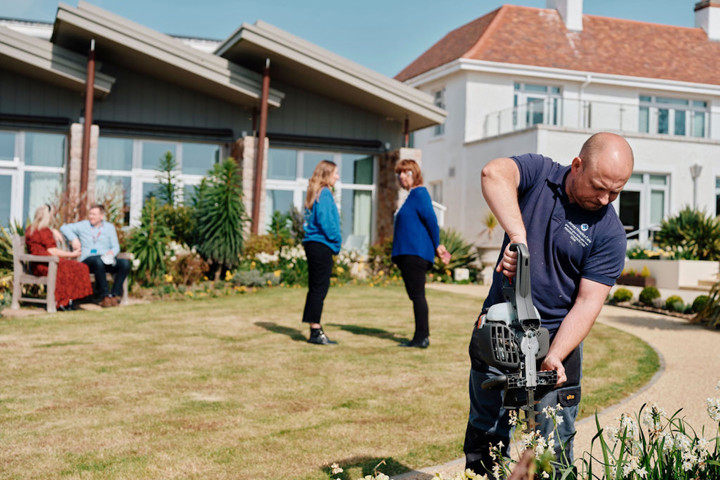 Image of Hospice Gardens with facilities working and people talking