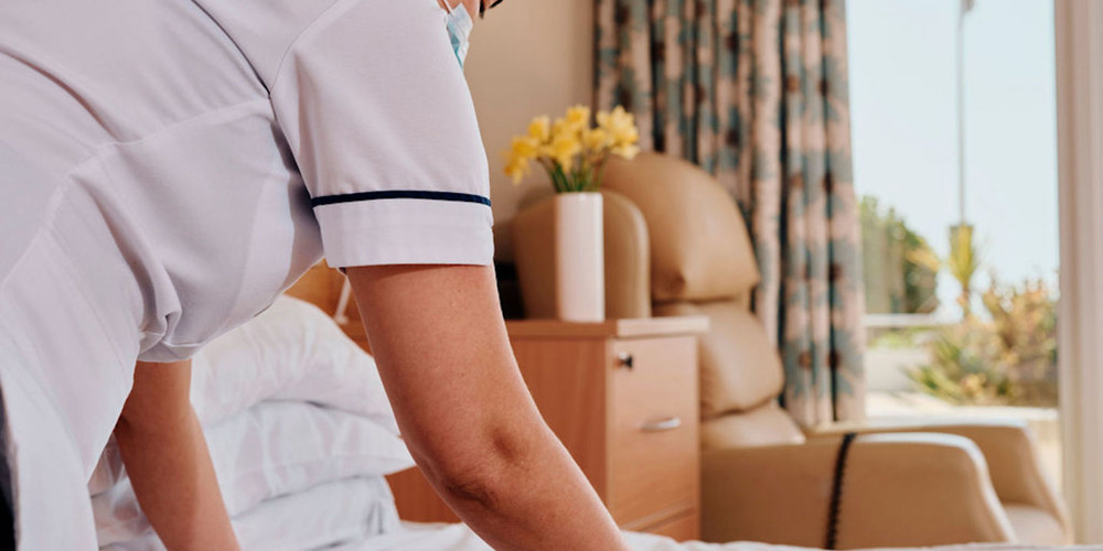 Image of nurse making a bed in room at Jersey Hospice Care In Patient Unit