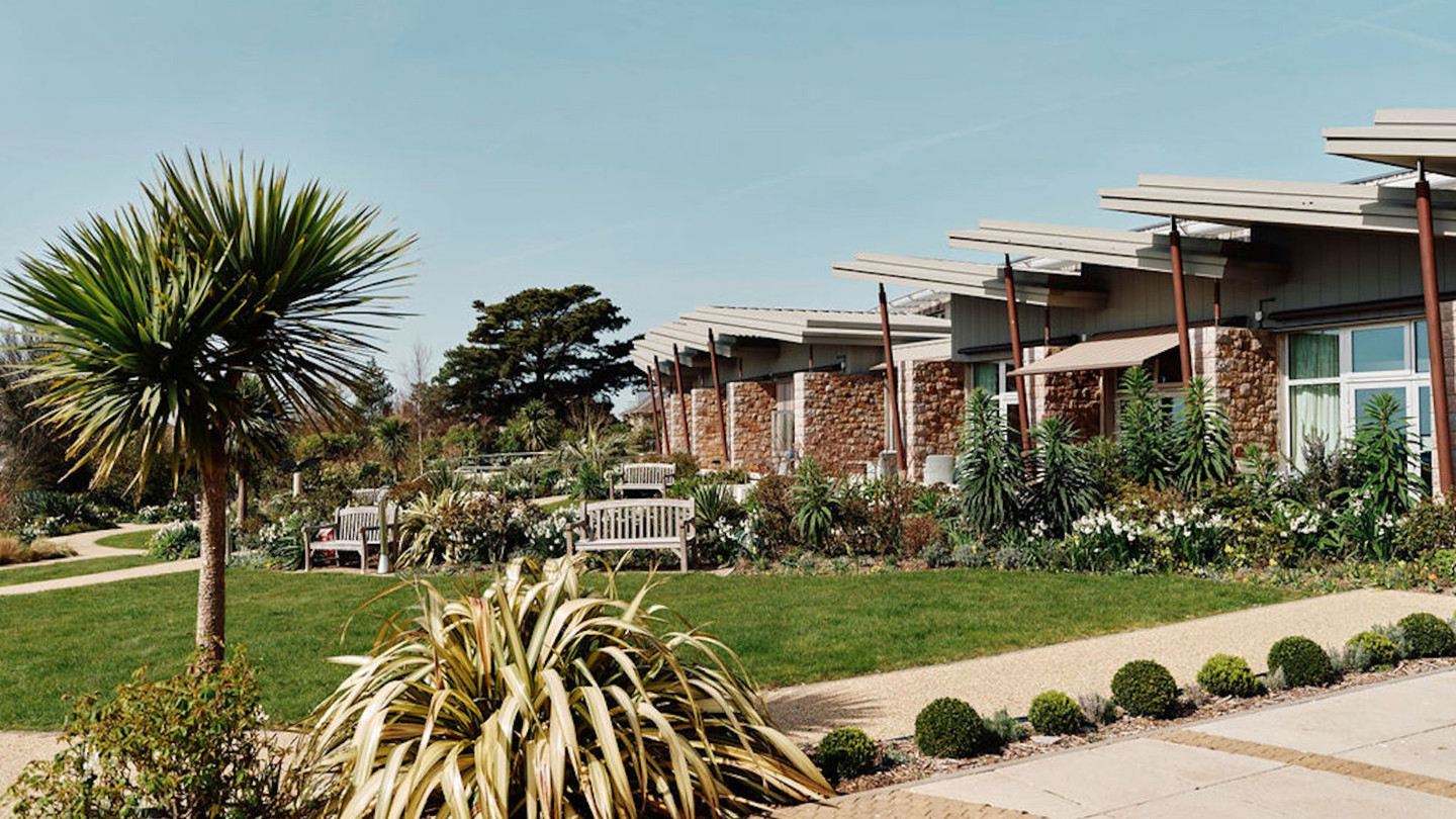 Image of hospice gardens with in patient unit in the background 