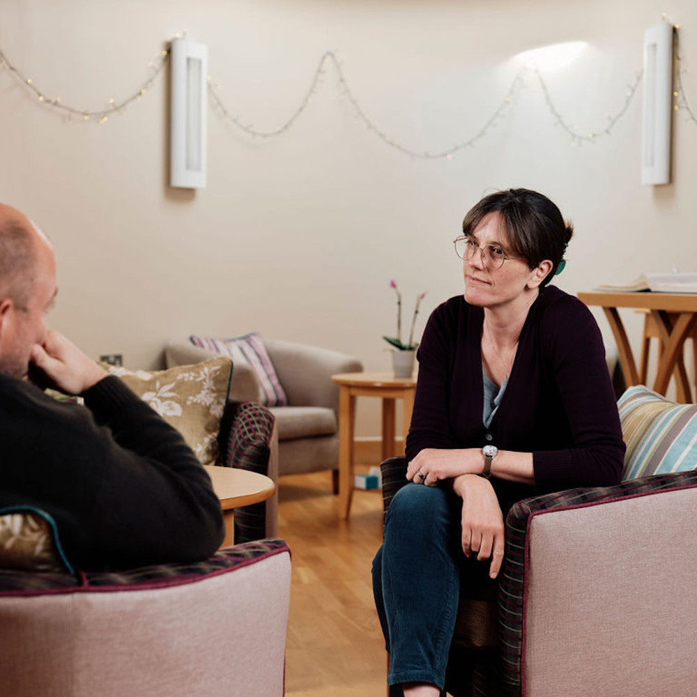 Image of Rev Emily in the Sanctuary talking to patient 