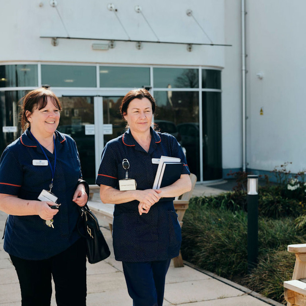 Image of Jersey Hospice Care nurses walking outside Hospice 