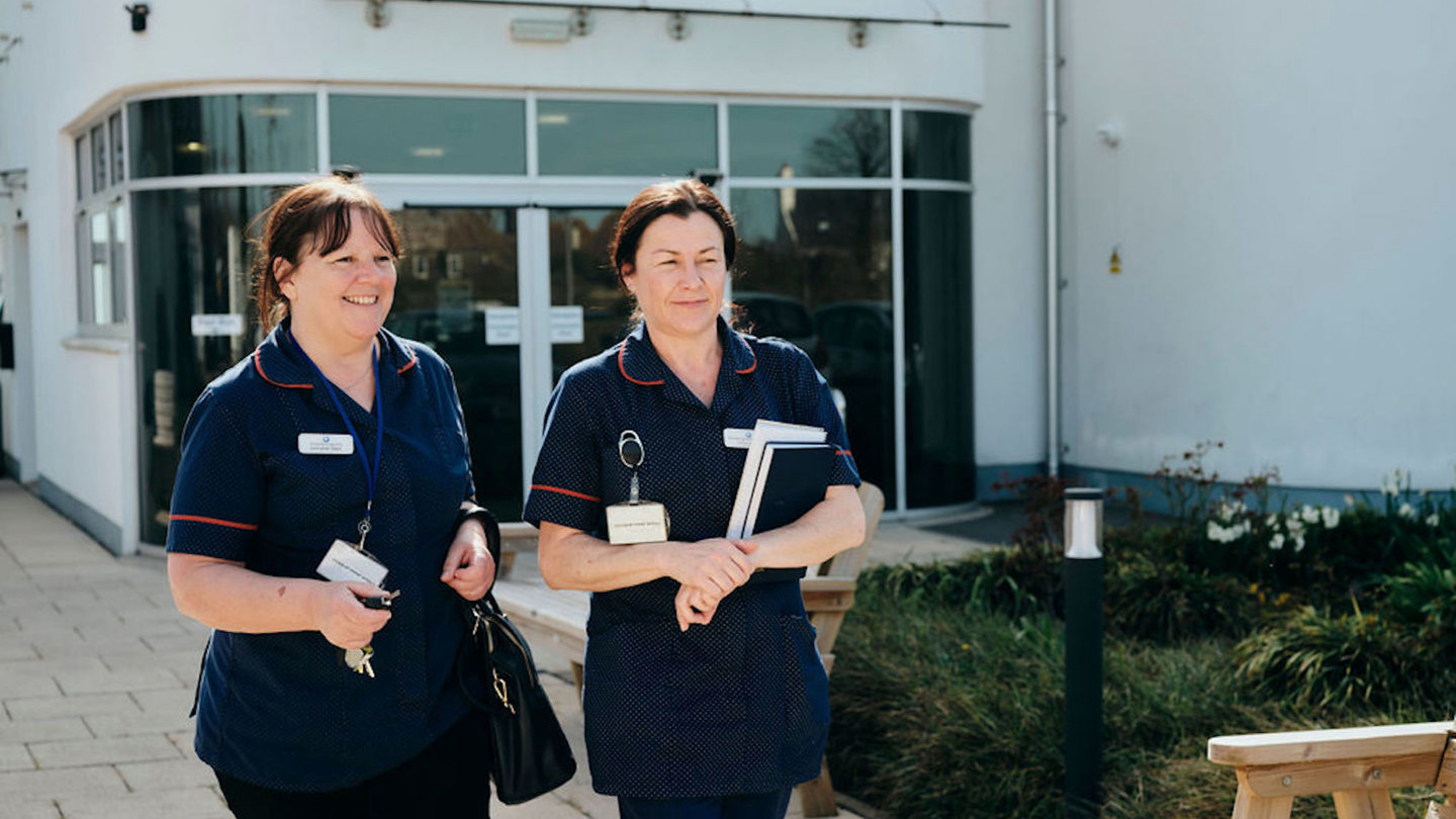 Image of Jersey Hospice Care nurses walking outside Hospice 