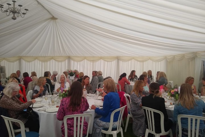 Image of ladies in marquee eating lunch 