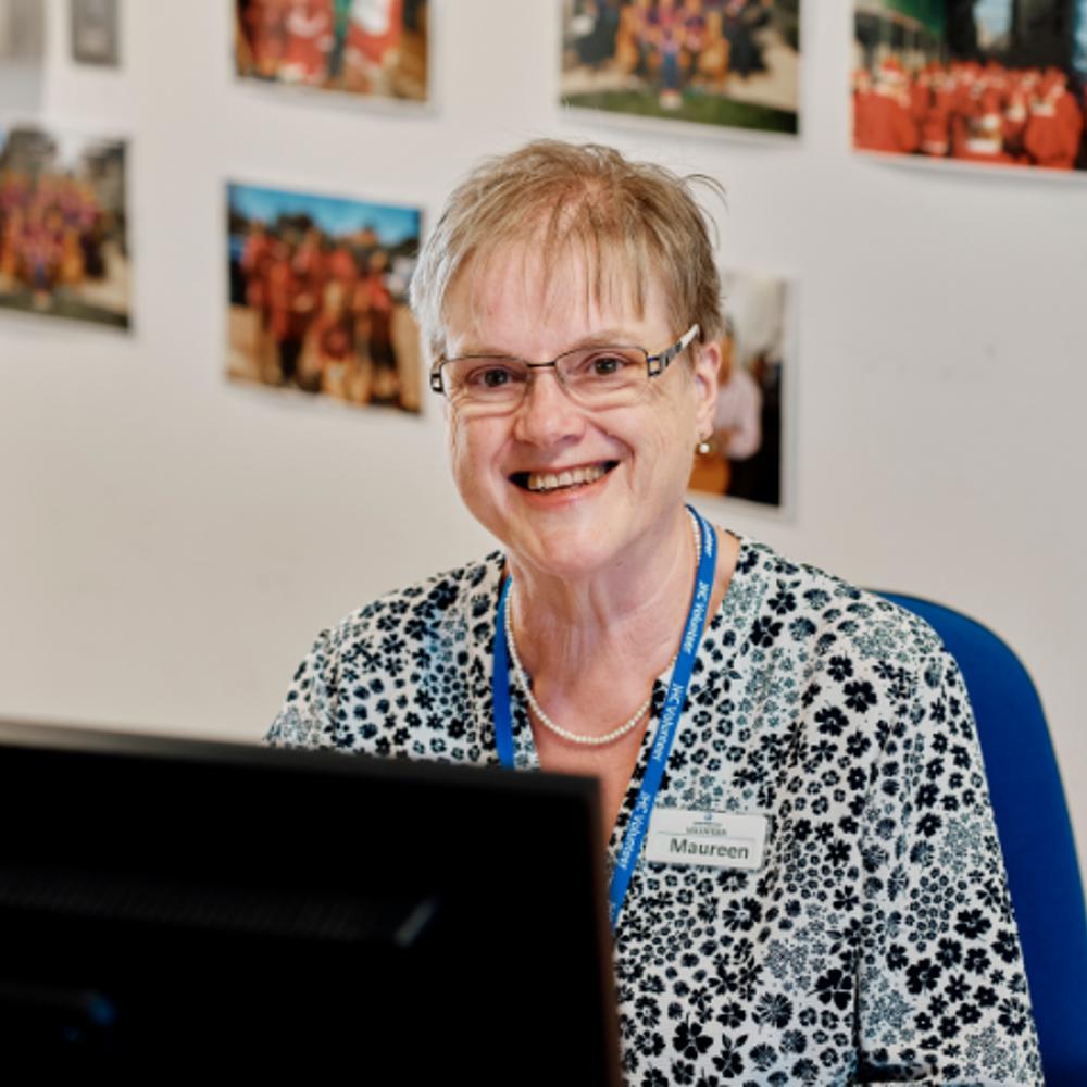 Image of admin volunteer at a computer at jersey hospice care